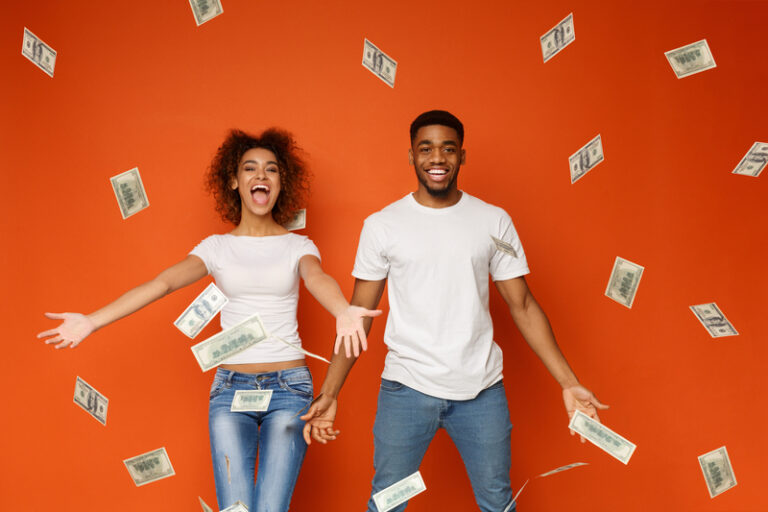 Man and woman with money flying around them