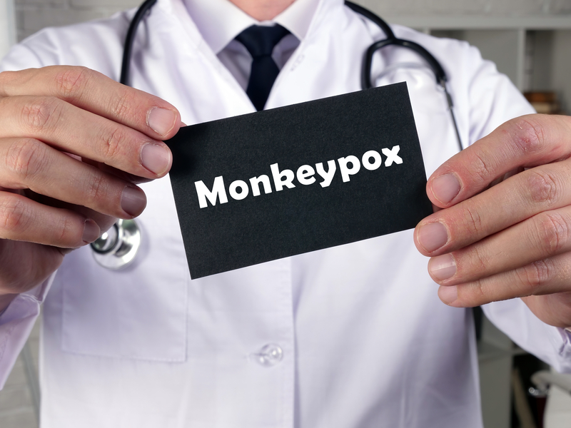 Doctor holding a card with words Monkeypox